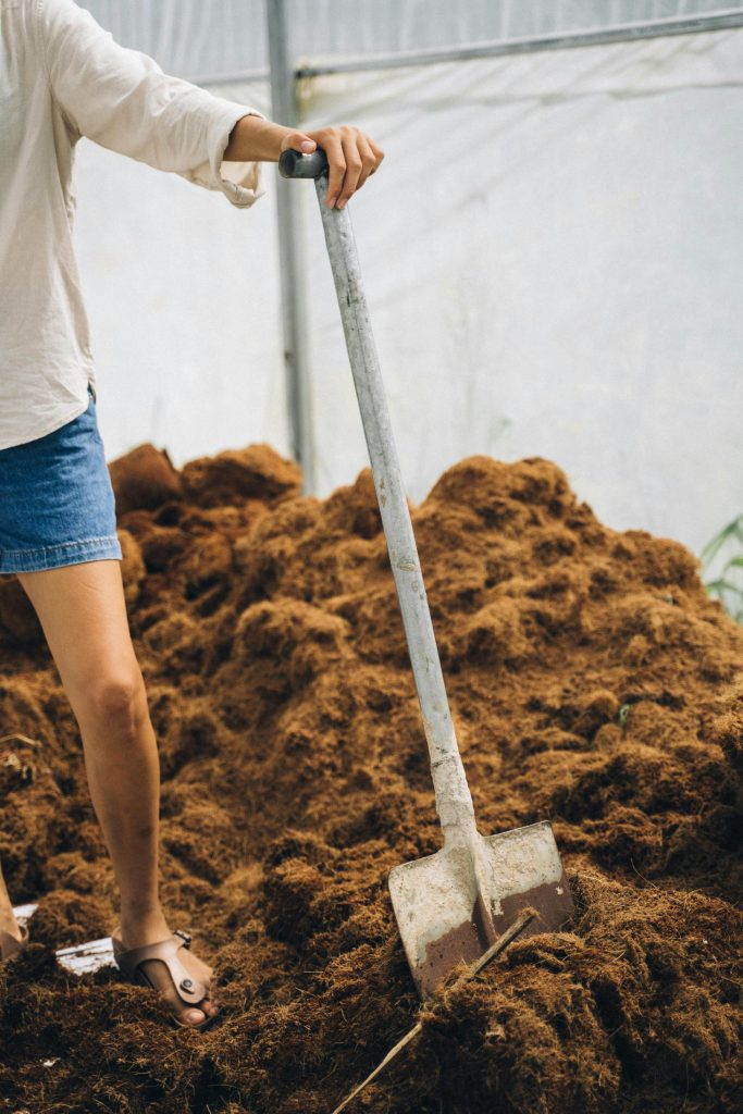 Compost With Woman And Shovel