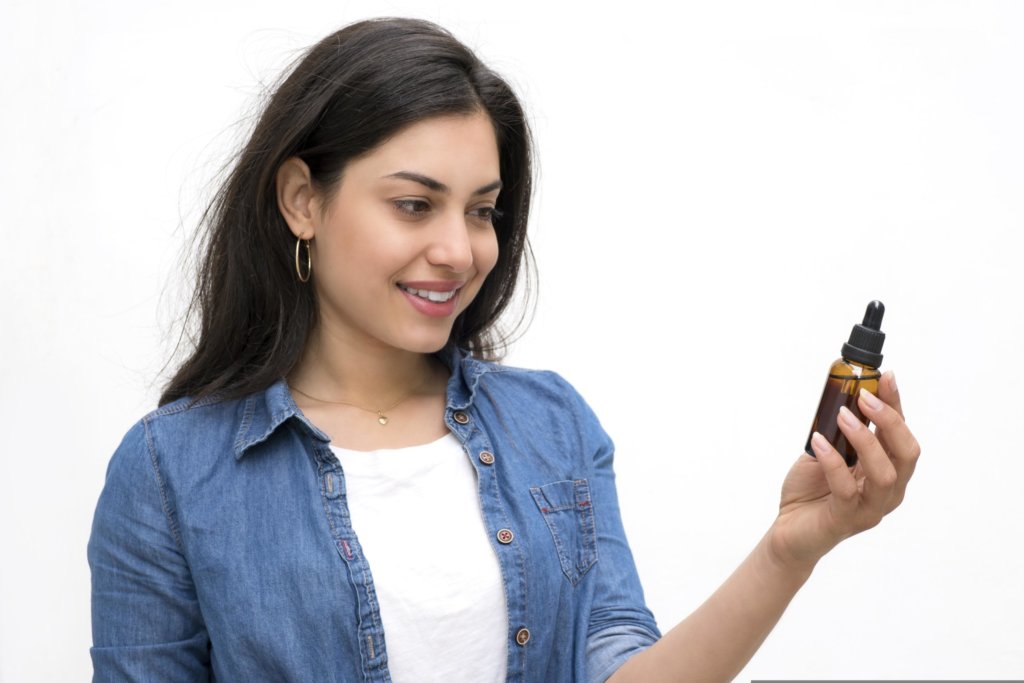 woman holding a cactus oil
